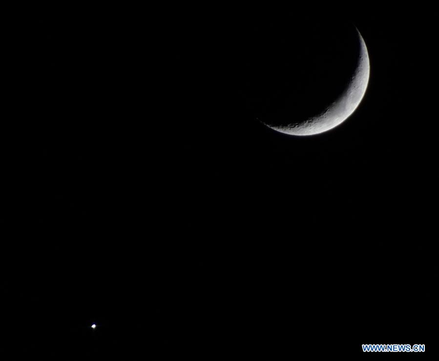 Crescent moon and bright planet Venus seen in