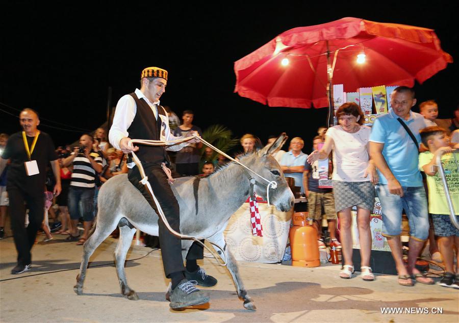 Traditional donkey race held in Croatia CROATIA-TRIBUNJ-DONKEY RACE