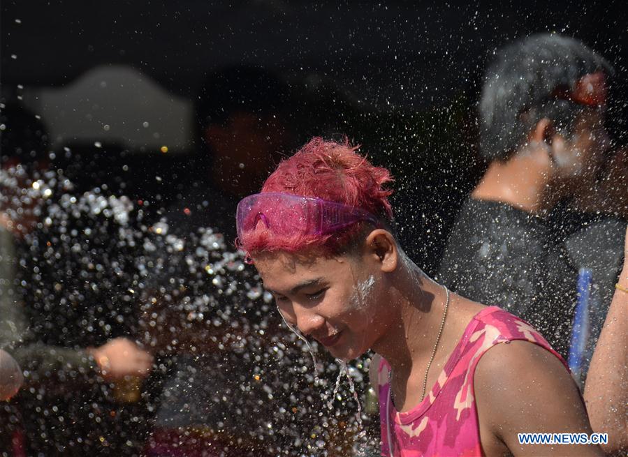 people celebrate songkran festival in vientiane, laos