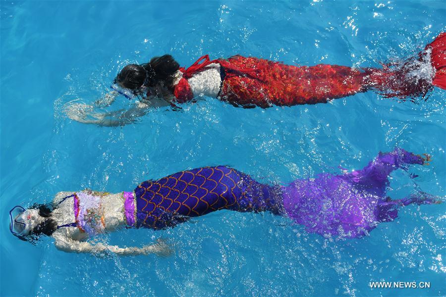 tourists swim with mermaid tails to beat heat
