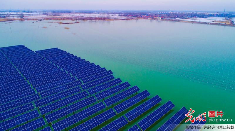Scenery of solar photovoltaic panels at reservoir in E China