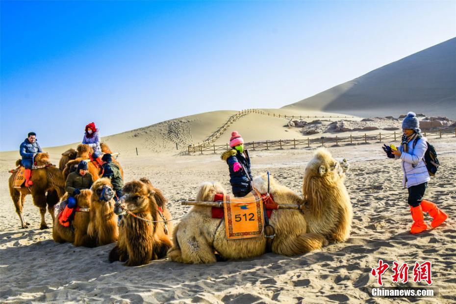 Tourists attracted by camel riding in NW China’s Duhuang