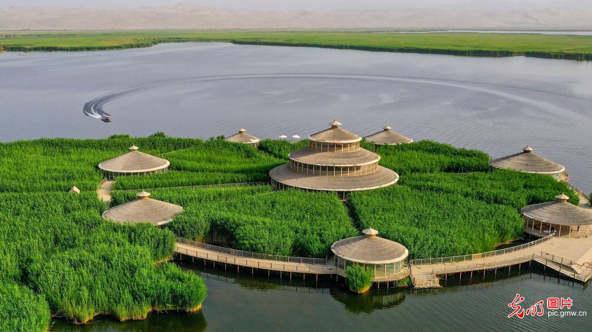 Tourists enjoy beautiful scenery of Bosten Lake, NW China's Xinjiang