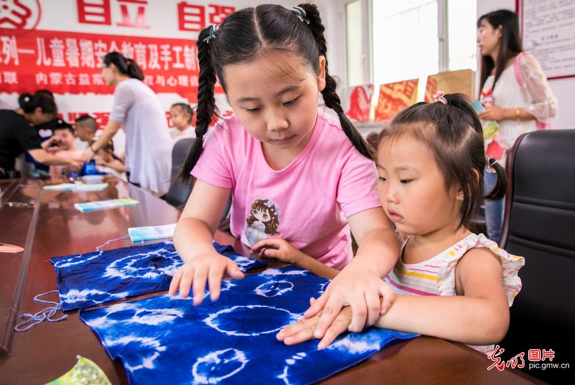 Children learn making skills of intangible cultural heritages during summer vacation in Hohhot, N China’s Inner Mongolia