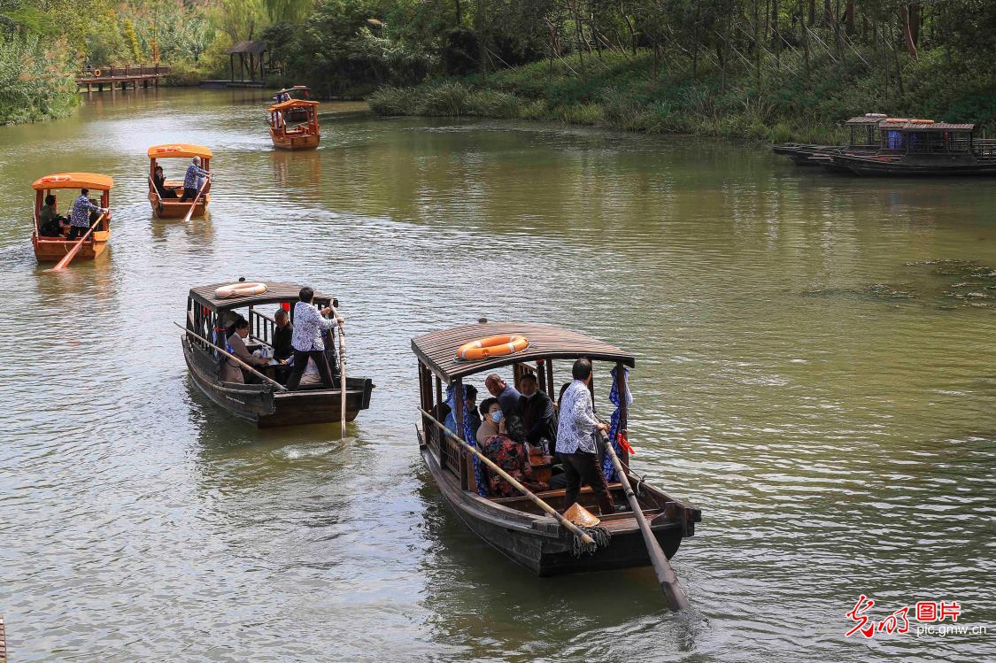 Tourists enjoying boat trips at Qinhu National Wetland Park in E China's Jiangsu