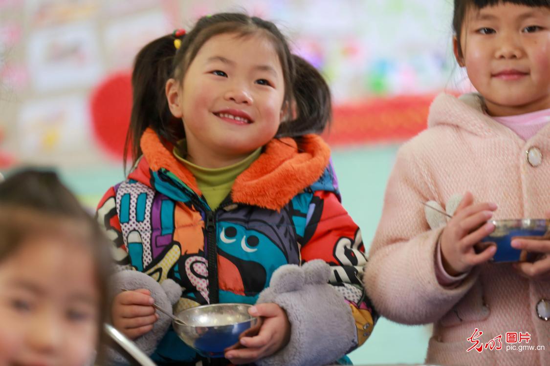 Kids learning to cook Laba Congee celebrating New Year