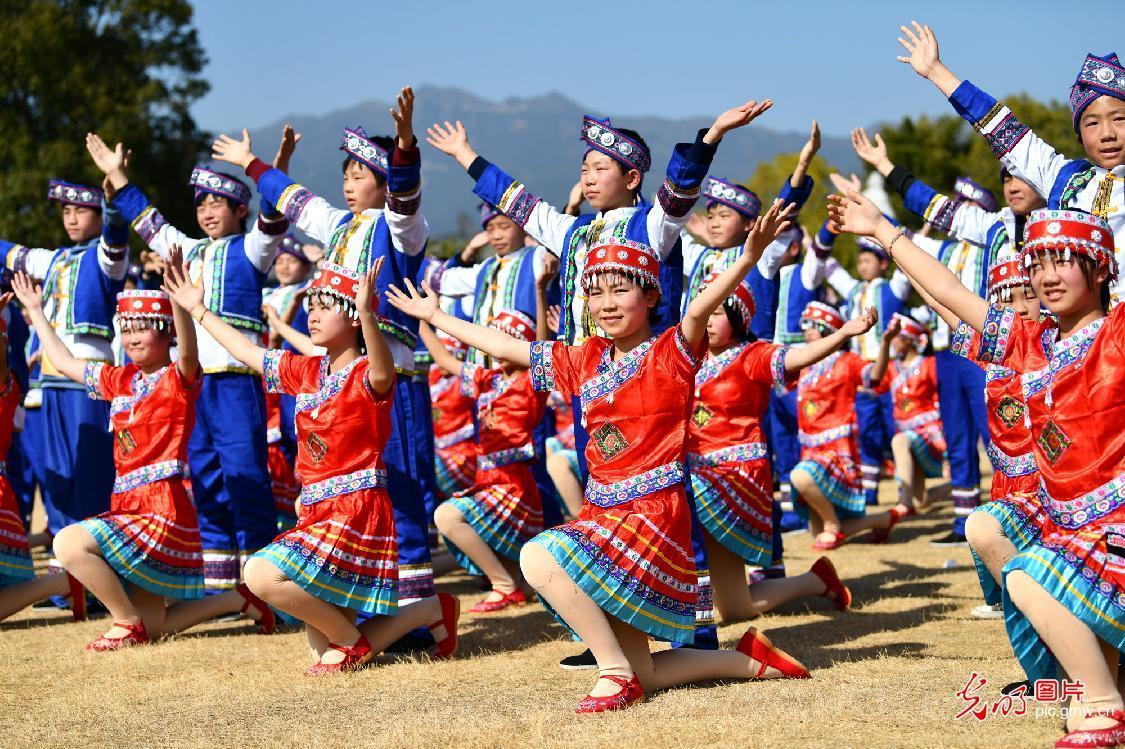 Students performing Yao folk dance in C China's Hubei