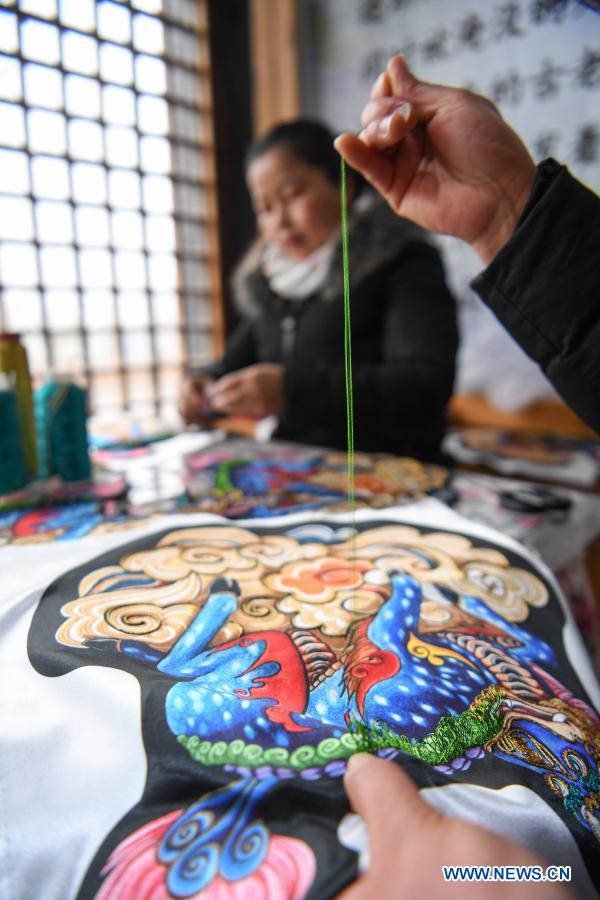 Local women make embroidery works in Shibing County, Guizhou
