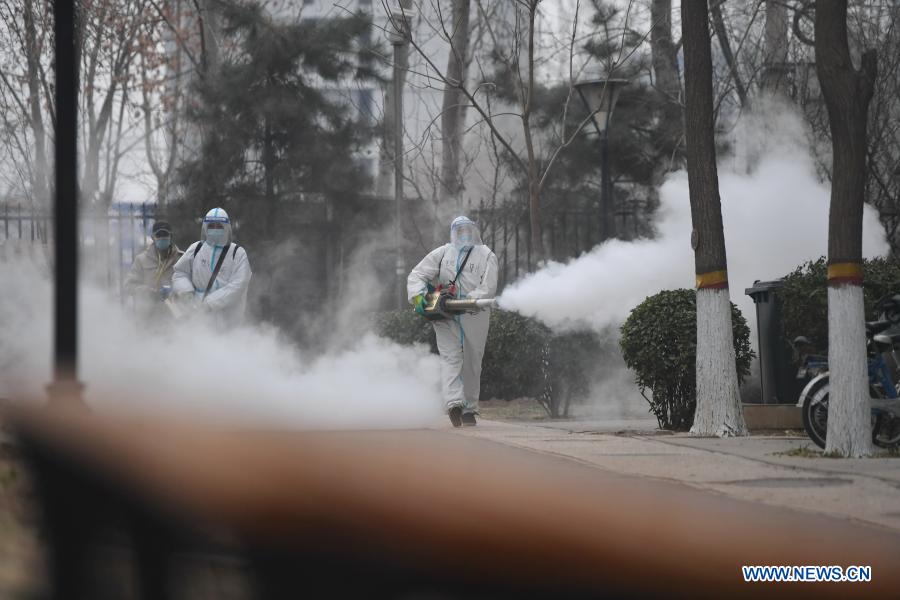 Staff members spray disinfectant at residential community to prevent spread of COVID-19 in Shijiazhuang