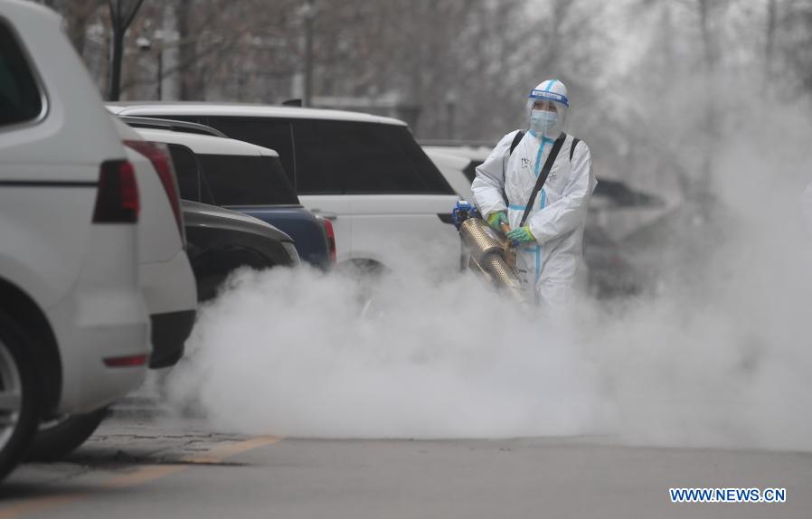 Staff members spray disinfectant at residential community to prevent spread of COVID-19 in Shijiazhuang