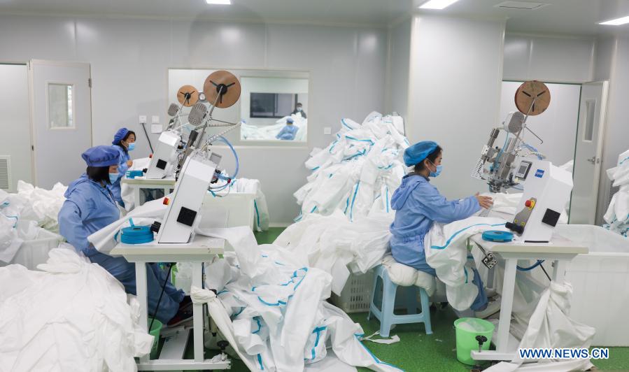 Workers make protective suits in Chongqing