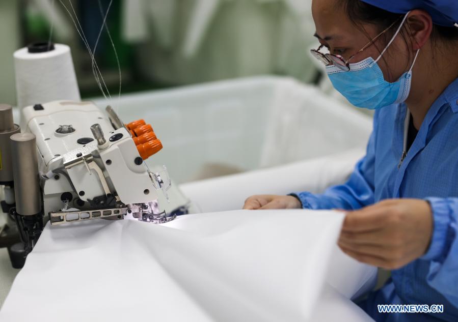 Workers make protective suits in Chongqing
