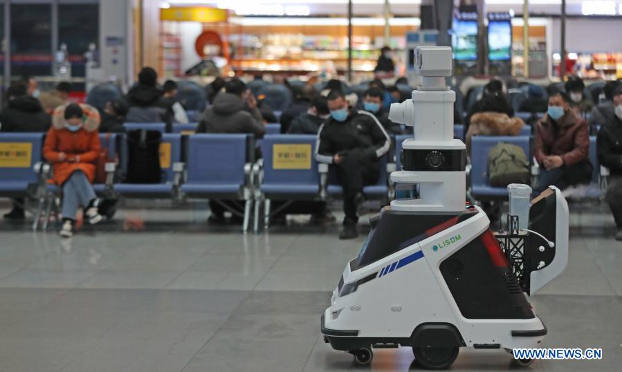 Disinfection, temperature-checking robot works at railway station in NE China