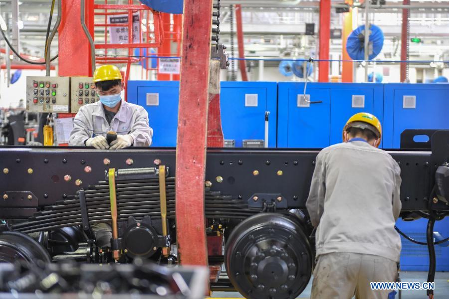 Workers work at assembly line of FAW Jiefang truck in Changchun