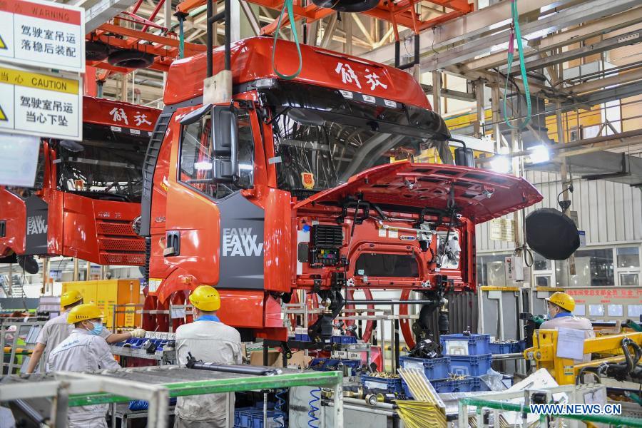 Workers work at assembly line of FAW Jiefang truck in Changchun