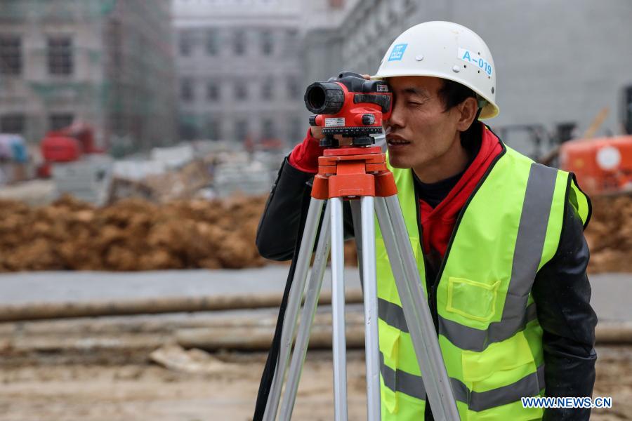 Workers celebrate upcoming Spring Festival at construction site in Guizhou