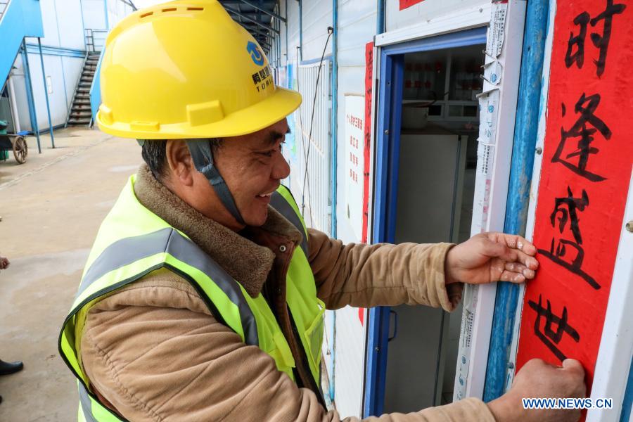 Workers celebrate upcoming Spring Festival at construction site in Guizhou