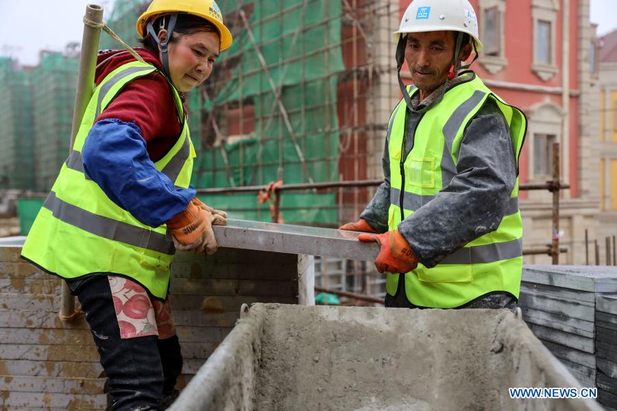 Workers celebrate upcoming Spring Festival at construction site in Guizhou