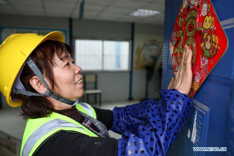 Workers celebrate upcoming Spring Festival at construction site in Guizhou