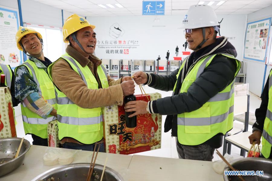 Workers celebrate upcoming Spring Festival at construction site in Guizhou