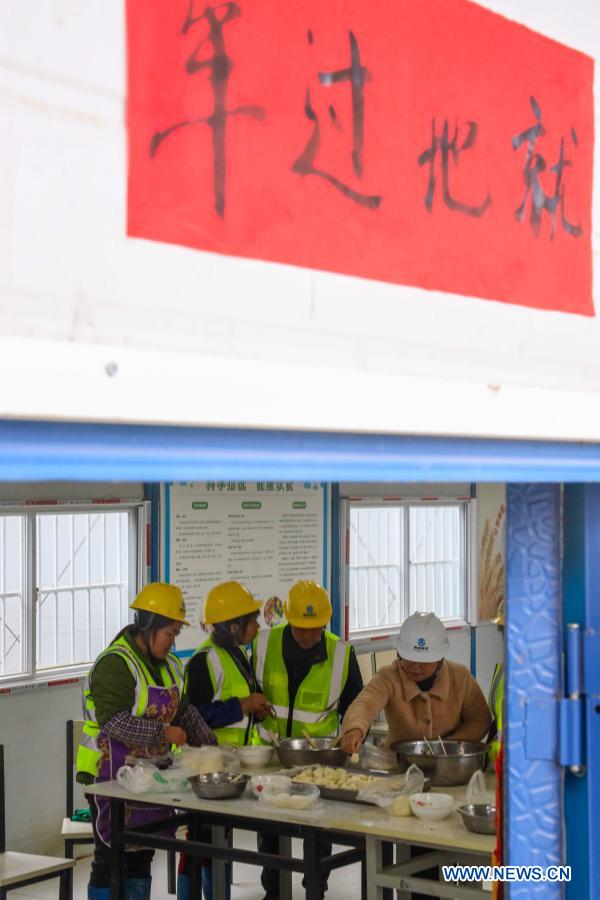 Workers celebrate upcoming Spring Festival at construction site in Guizhou