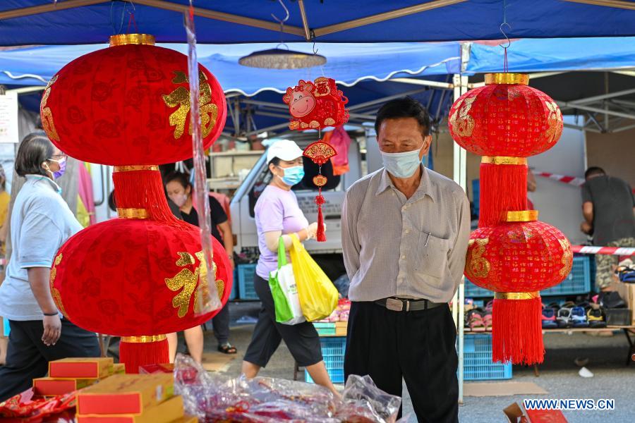 People shop for Chinese New Year decorations in Klang of Selangor state, Malaysia