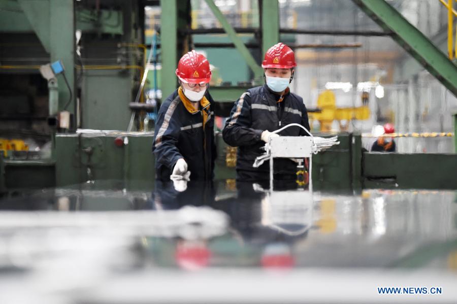 Staff members work at workshop of Light Alloy company in Harbin