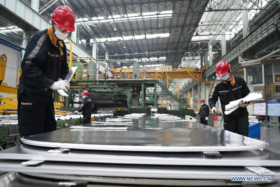 Staff members work at workshop of Light Alloy company in Harbin