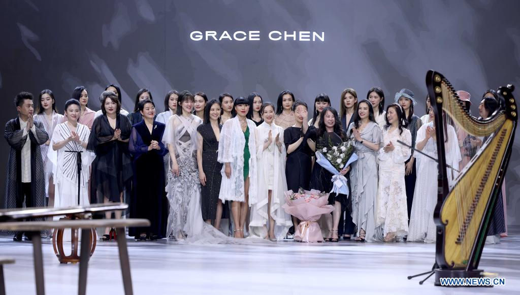 Models present creations of Grace Chen during China Fashion Week in Beijing