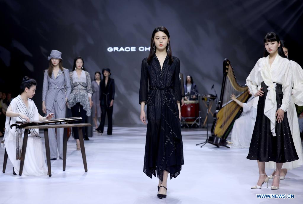 Models present creations of Grace Chen during China Fashion Week in Beijing