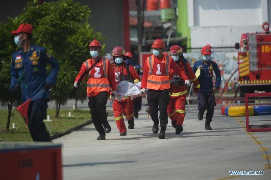 Firefighters compete during Fire Safety Challenge 2021 competition in Jakarta
