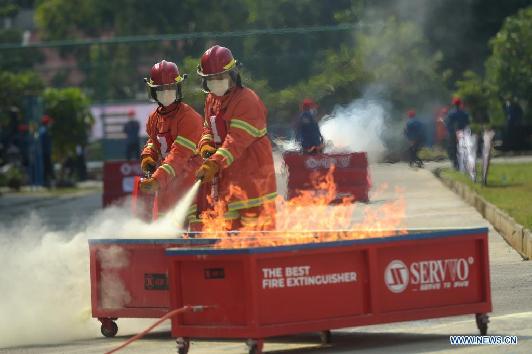 Firefighters compete during Fire Safety Challenge 2021 competition in Jakarta
