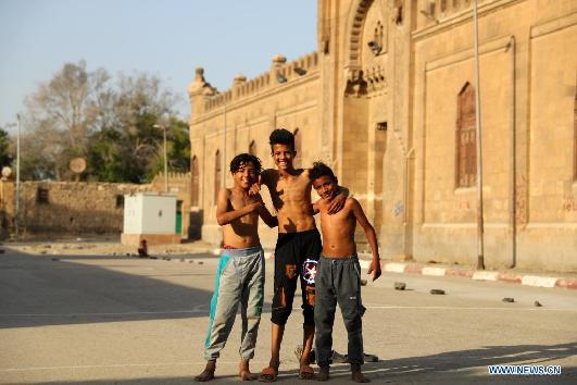 Children living in slum in Cairo play football on Int'l Children's Day