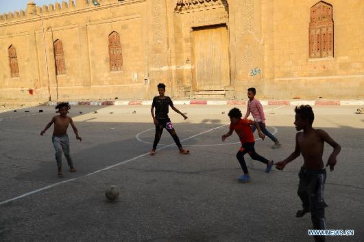 Children living in slum in Cairo play football on Int'l Children's Day