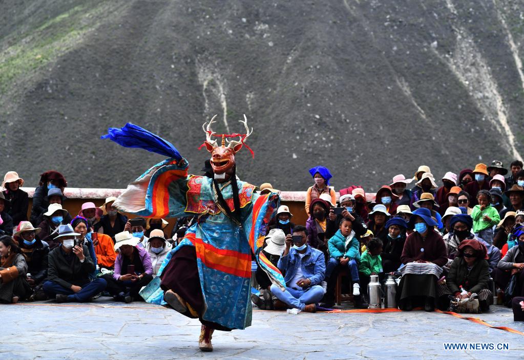 Buddhist monks perform Cham dance at Drigung Monastery in Lhasa, Tibet