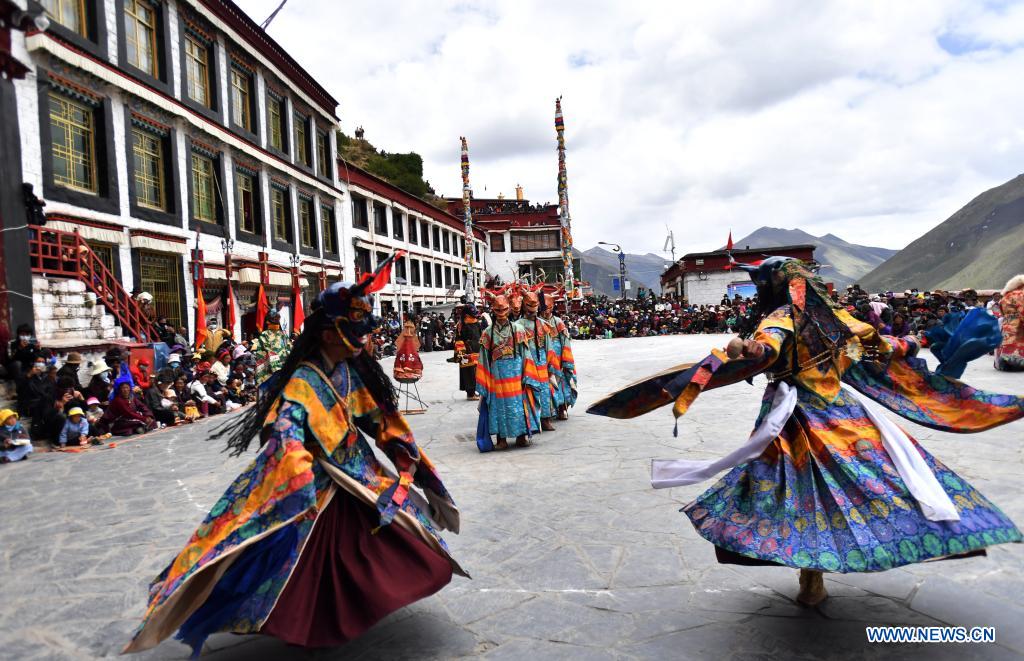 Buddhist monks perform Cham dance at Drigung Monastery in Lhasa, Tibet