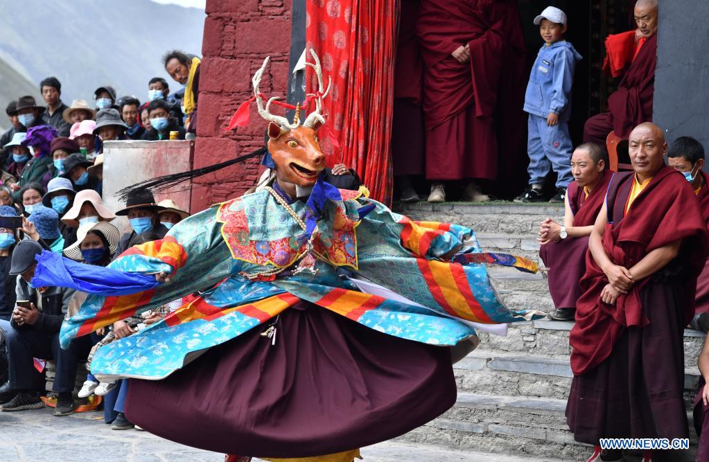 Buddhist monks perform Cham dance at Drigung Monastery in Lhasa, Tibet