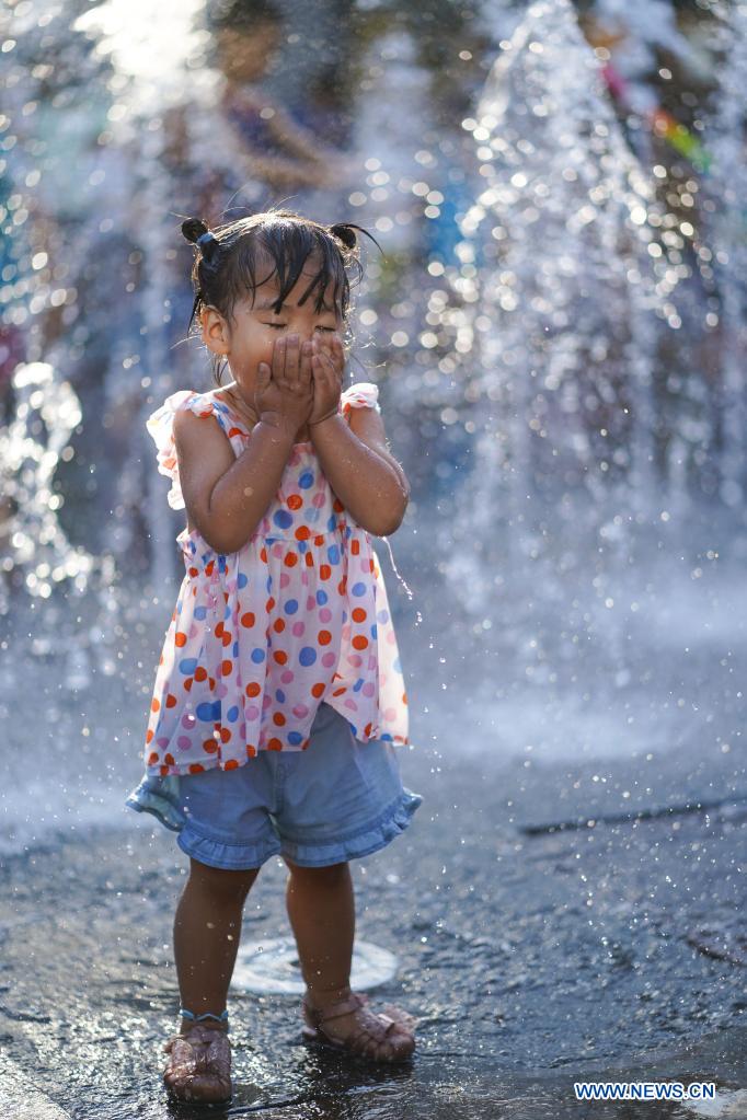 Children cool off at fountain in Beijing