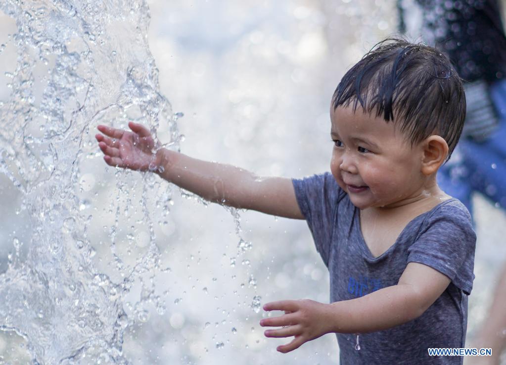 Children cool off at fountain in Beijing