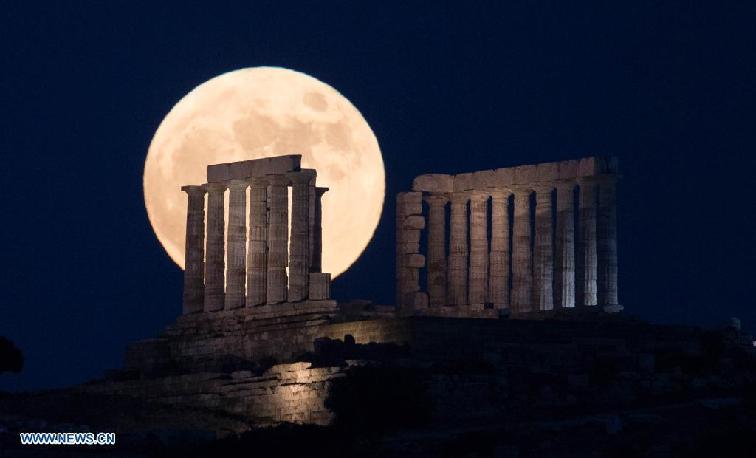 Full moon rises over Temple of Poseidon in Greece