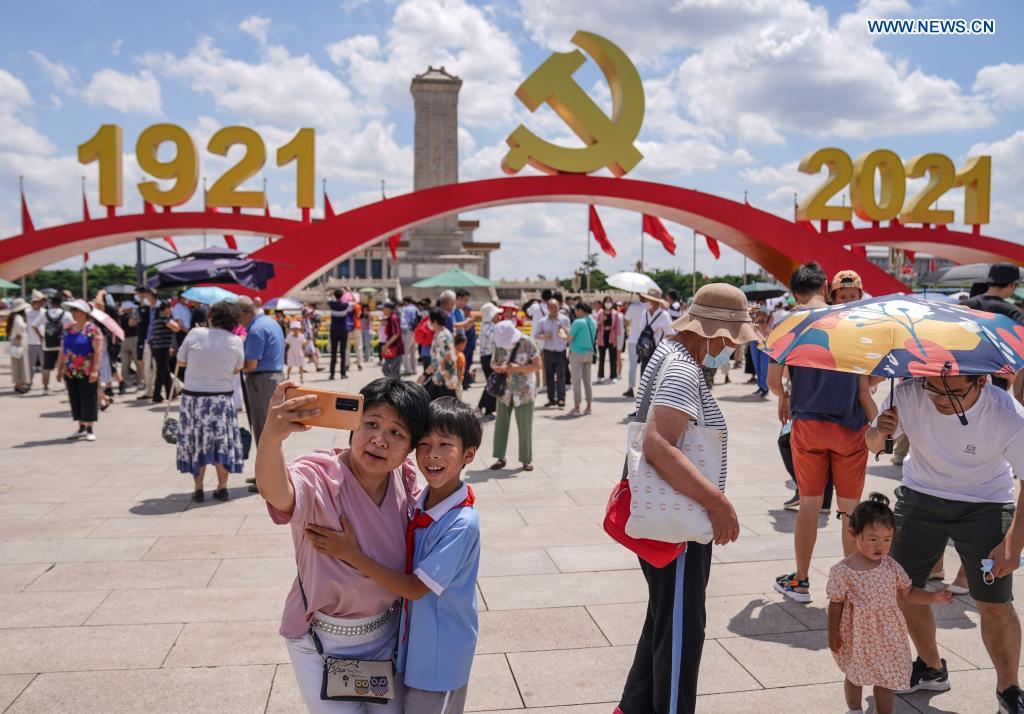 People take photos of ceremony decoration at Tian'anmen Square