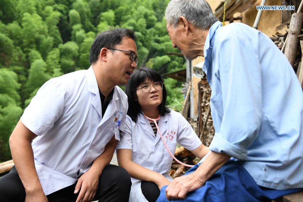 In pics: couple provides medical services for local villagers in Anhui