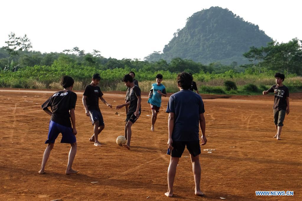 Villagers play football barefooted at Rumpin of Bogor district, Indonesia