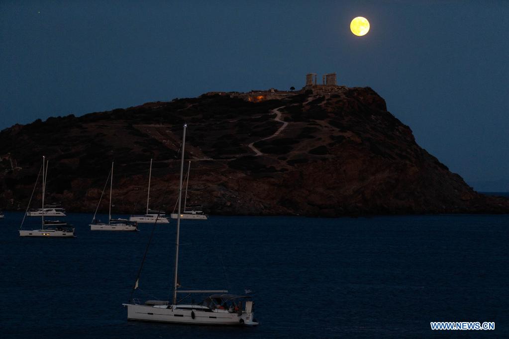 Full moon seen over Temple of Poseidon in Greece