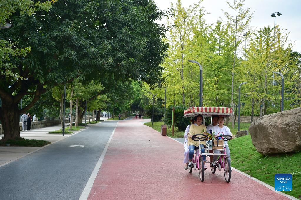 Residents spend leisure time in waterside walkway built in Yunyang district of Chongqing