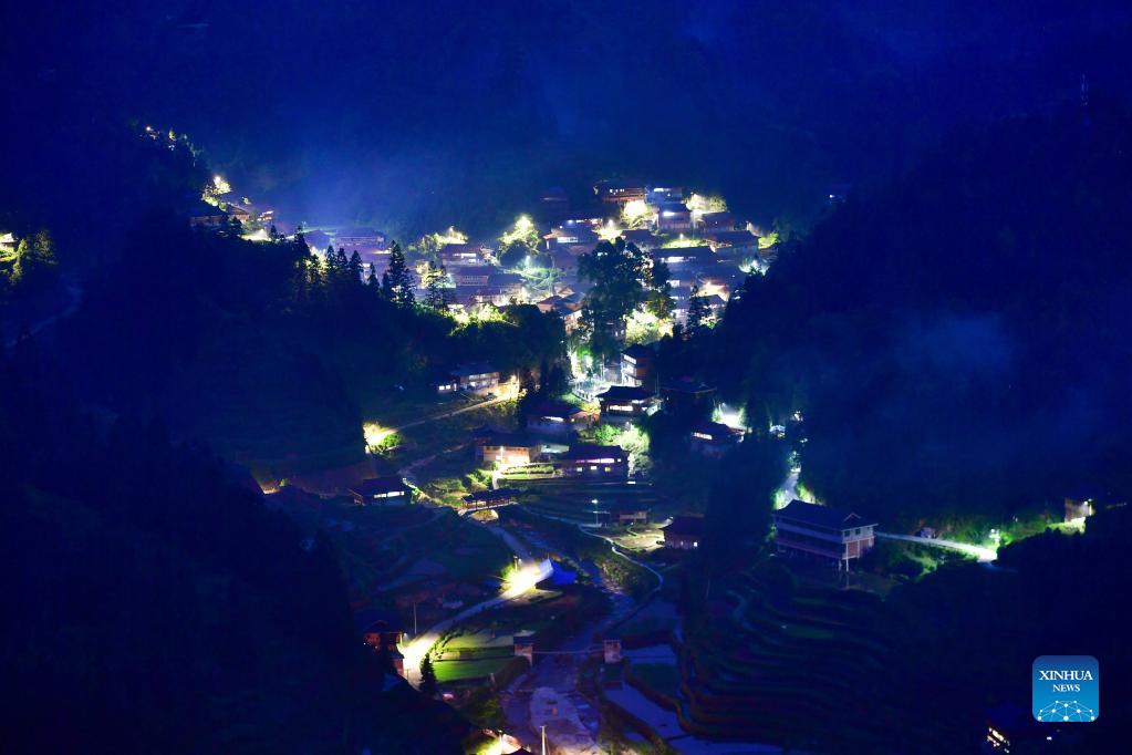 Solar powered street lamps illuminate night sky in south China