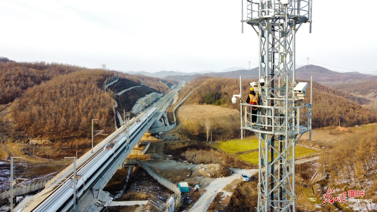 Technicians inspect high speed railway communication tower in C China's Henan