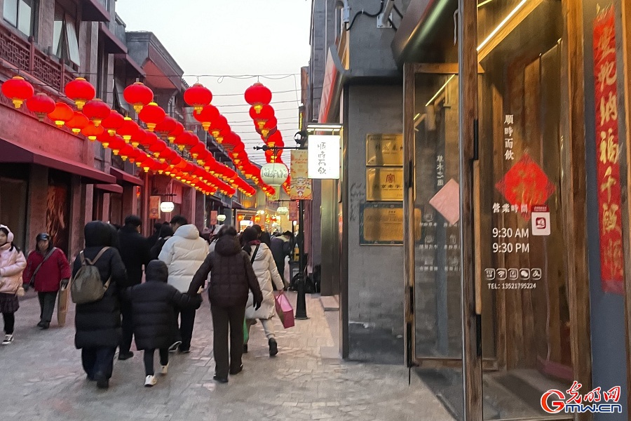 People enjoy festive decorations at Qianmen during Spring Festival