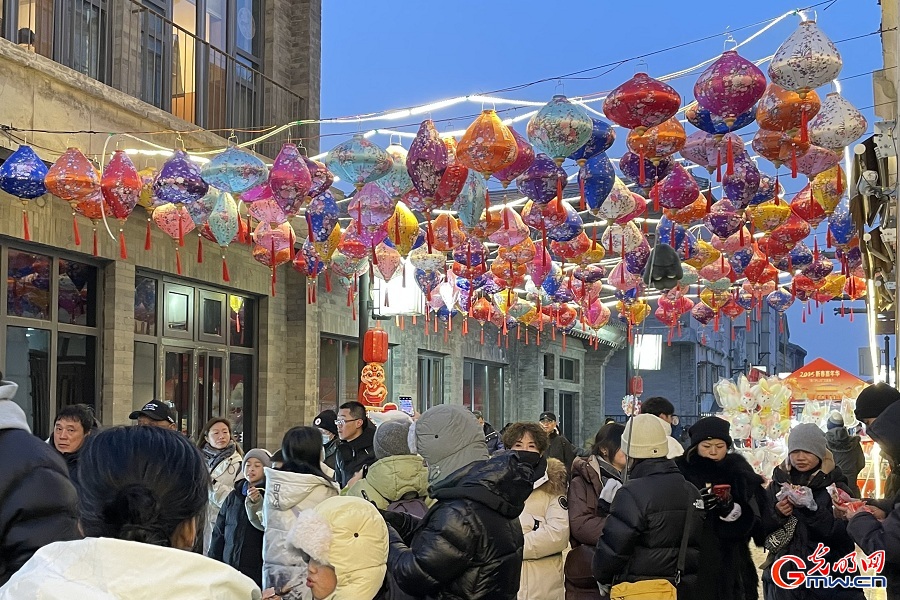 People enjoy festive decorations at Qianmen during Spring Festival