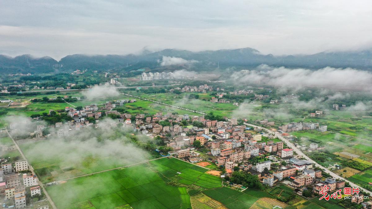 Mist-enveloped village in S China's Guangxi